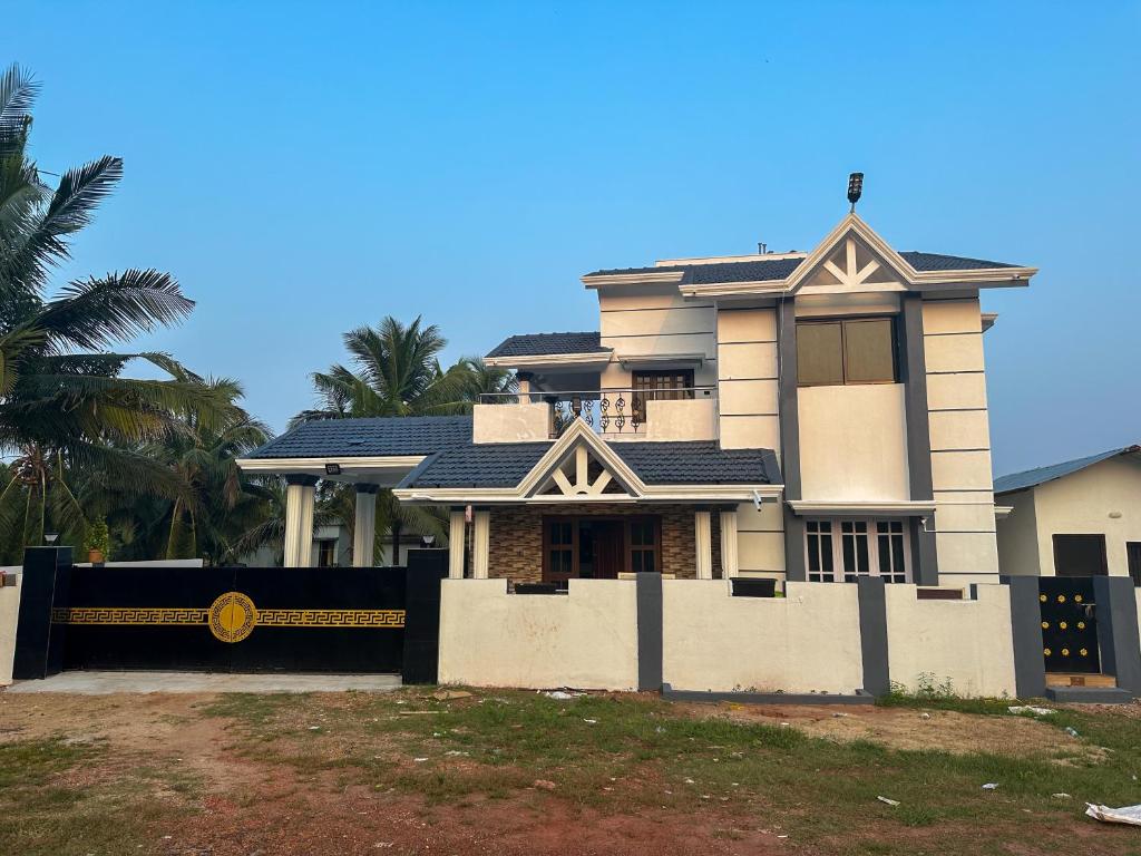 a house with a fence in front of it at 4bhk Luxury Villa in Mangalore