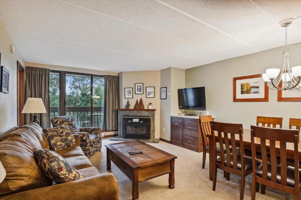 a living room with a couch and a table at Pinnacle F01 in Killington