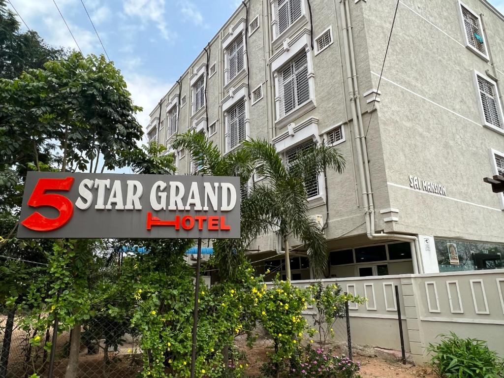 a star grand hotel sign in front of a building at Hotel 5 star grand in Shamshabad