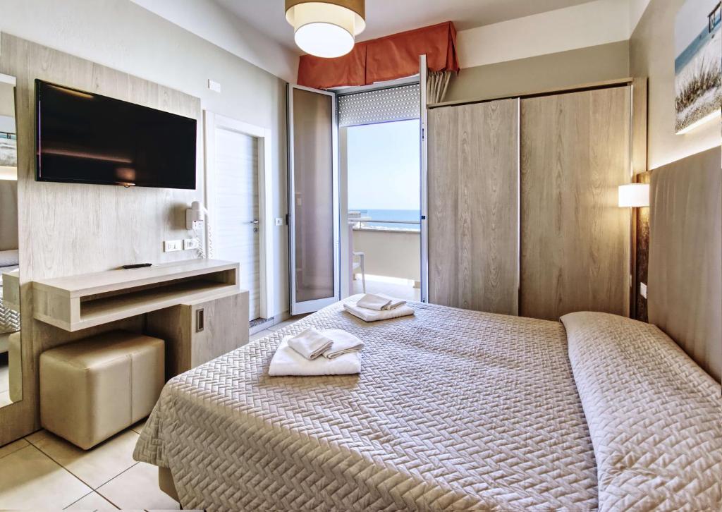 Postel nebo postele na pokoji v ubytování Hotel Alba D'Oro