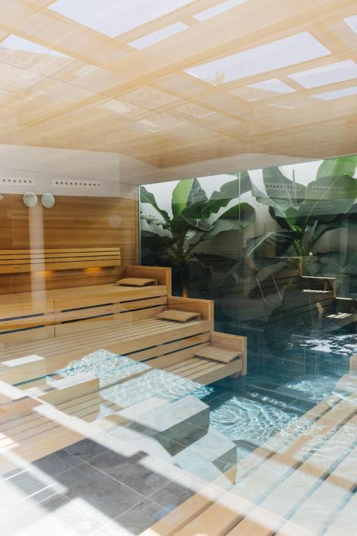 a room with wooden benches and a painting on the wall at BANCAL HOTEL and SPA in San Sebastián de la Gomera