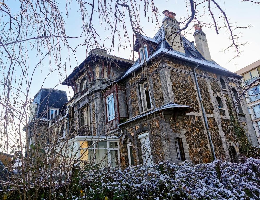 an old stone house with snow on the roof at Seine-Front Apt in Stone House with parking and garden, Lacroix Island in Rouen