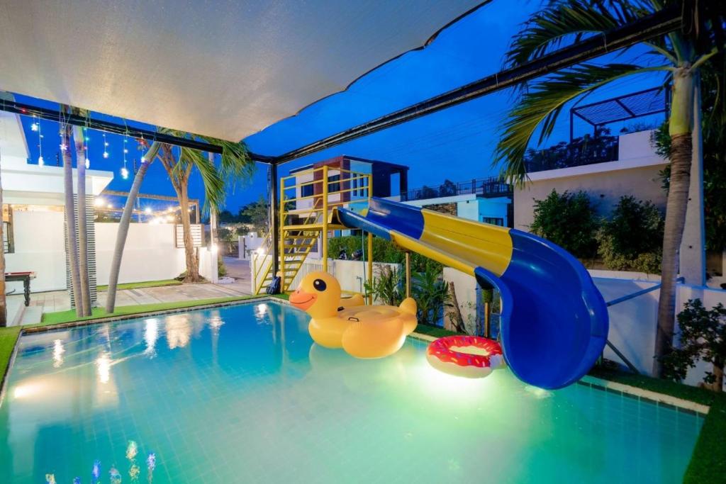 a slide in a swimming pool with two rubber ducks at City Beach 3 Pool Villa Hua Hin in Hua Hin