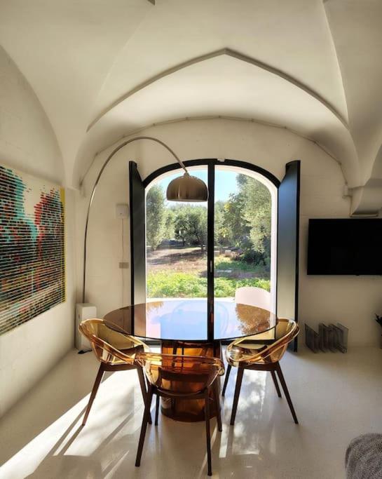 a dining room with a table and chairs and a window at Casa Lama in Monopoli