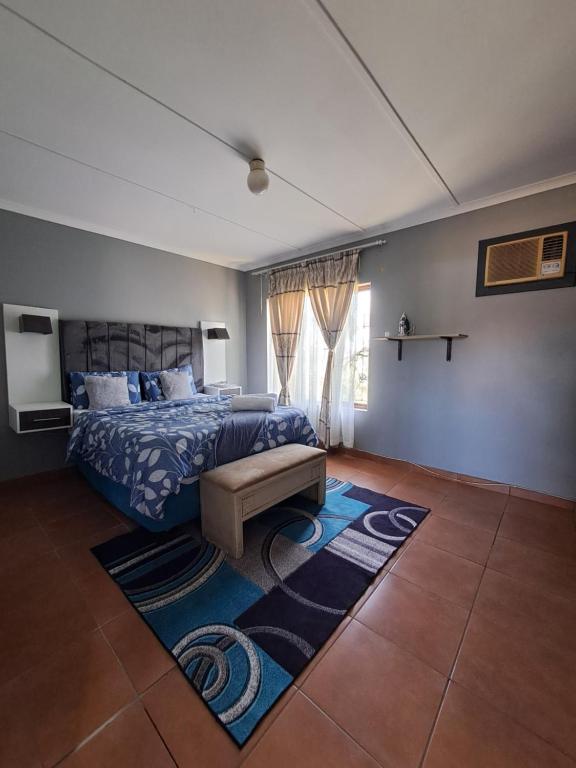 a bedroom with a bed and a rug in a room at Rubie's self-catering home in Durban