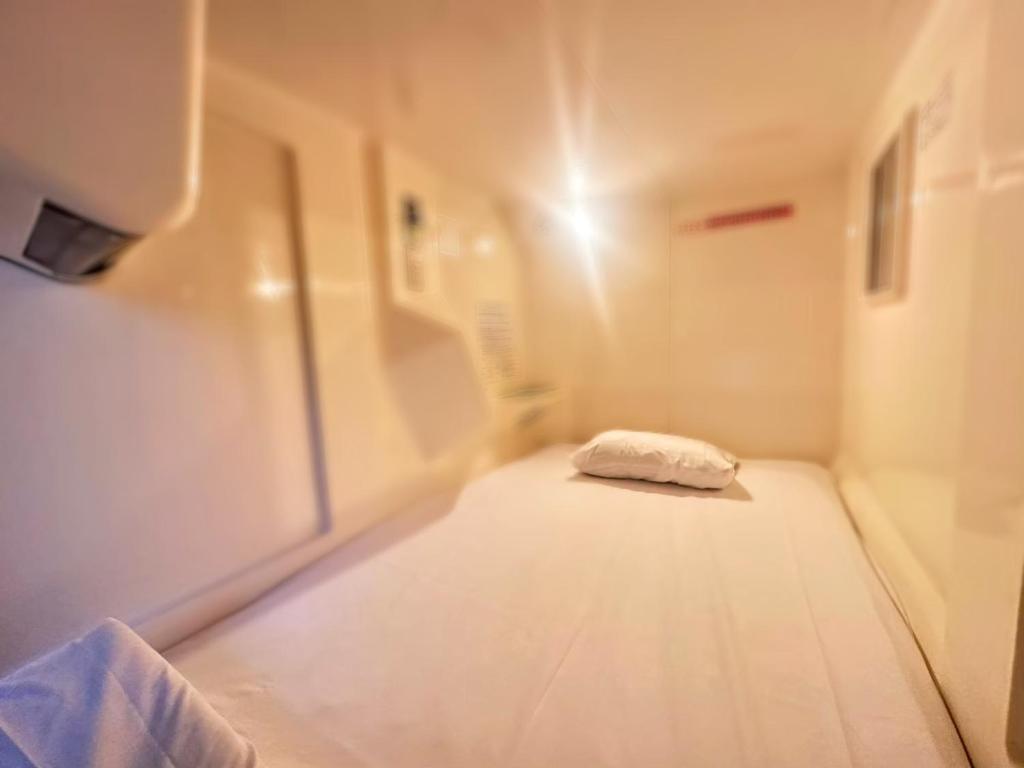 Postel nebo postele na pokoji v ubytování カプセルイン大塚