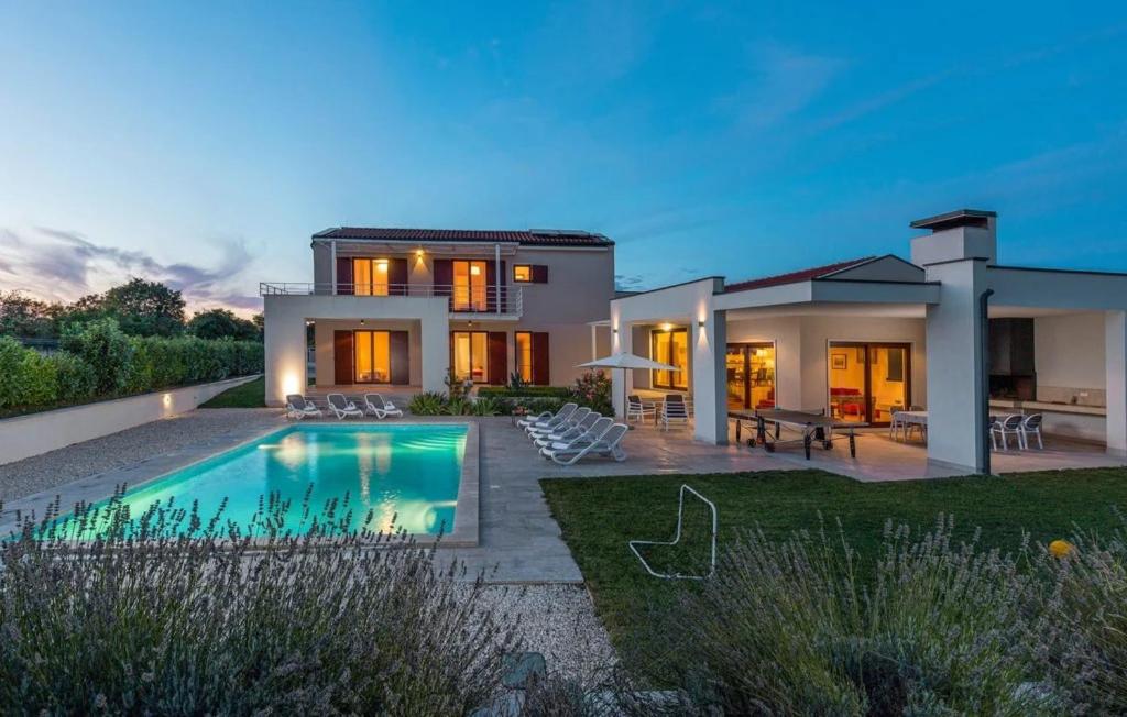 a house with a swimming pool in the yard at Villa Dora in Central Istria kids friendly with private pool and playground for 10 persons in Svetvinčenat