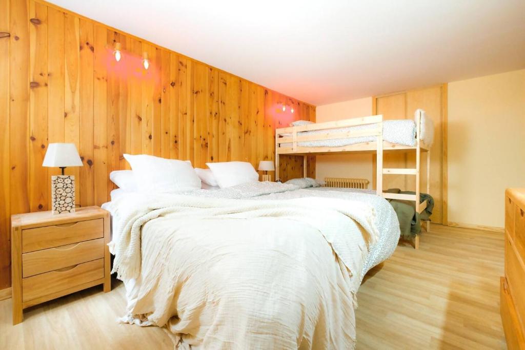 a bedroom with wooden walls and a bunk bed at Villa Garmet | Formigal in Formigal