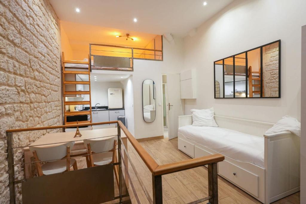 a bedroom with a bed and a desk in a room at Loft 2 BR Marais, Notre Dame AC by LCC Agency in Paris