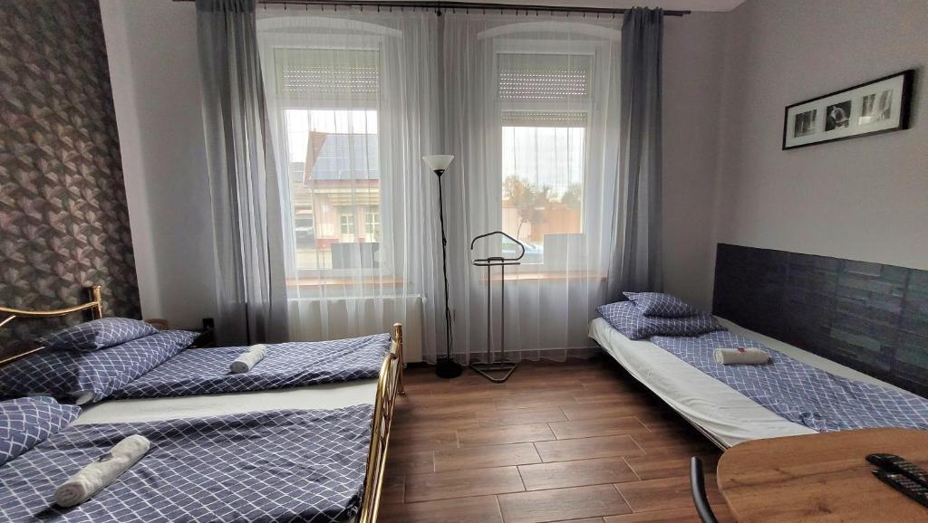 Łóżko lub łóżka w pokoju w obiekcie Megyeház Apartman