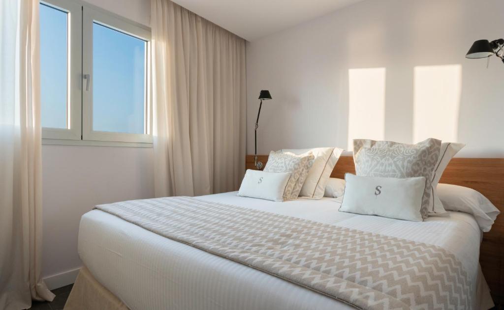 A bed or beds in a room at Pure Salt Residences