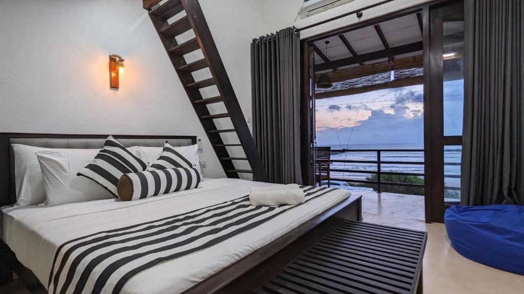 een slaapkamer met een bed met uitzicht op de oceaan bij Surf edge villa in Mawella