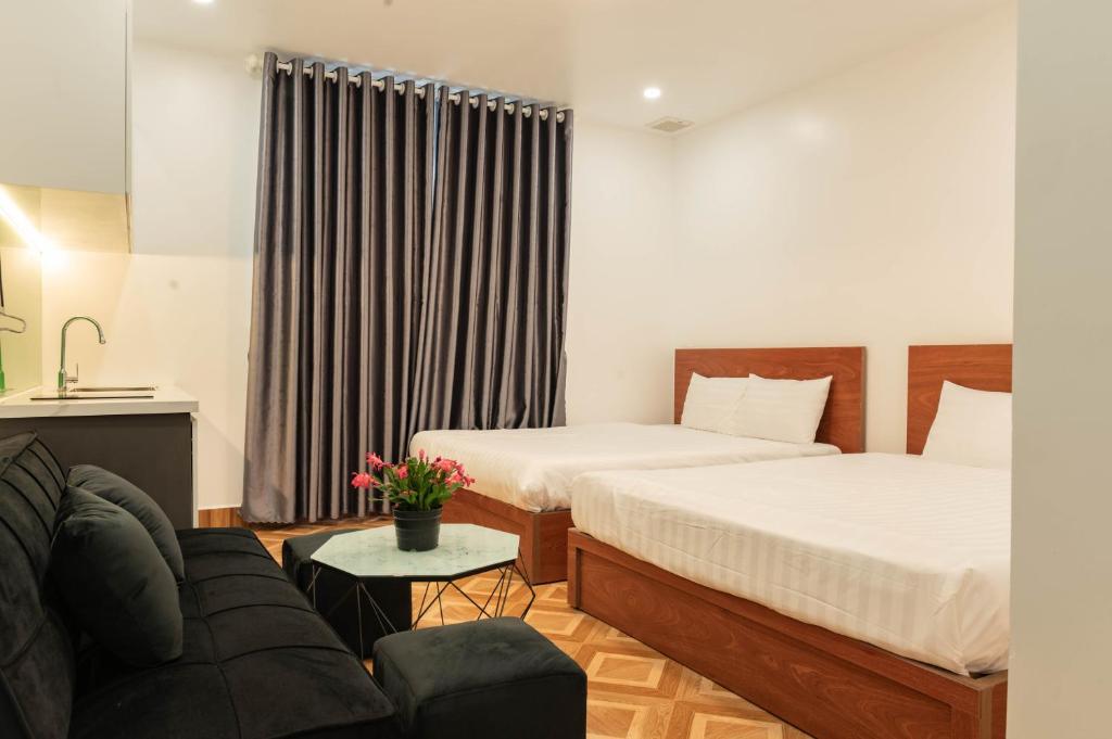 Postel nebo postele na pokoji v ubytování LÉ BOISE HOTEL Đà Lạt