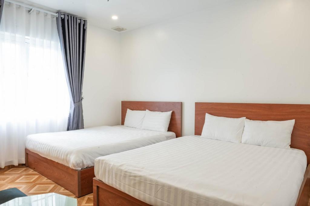 Postel nebo postele na pokoji v ubytování LÉ BOISE HOTEL Đà Lạt