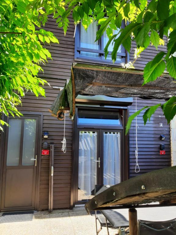 un bâtiment avec une porte et un banc devant dans l'établissement Duplex14h 1er étage jardinet 1 parking ou studio14B rdc terrasse sans parking, à La Rochelle