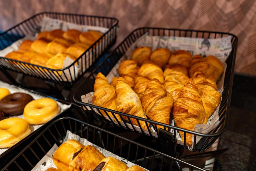 a bunch of baskets filled with different types of bread at ASA Hotel La Marina in Ondara