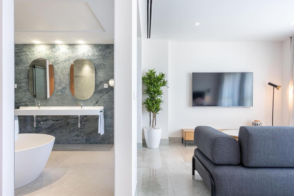 two views of a bathroom and a living room at ASA Hotel La Marina in Ondara