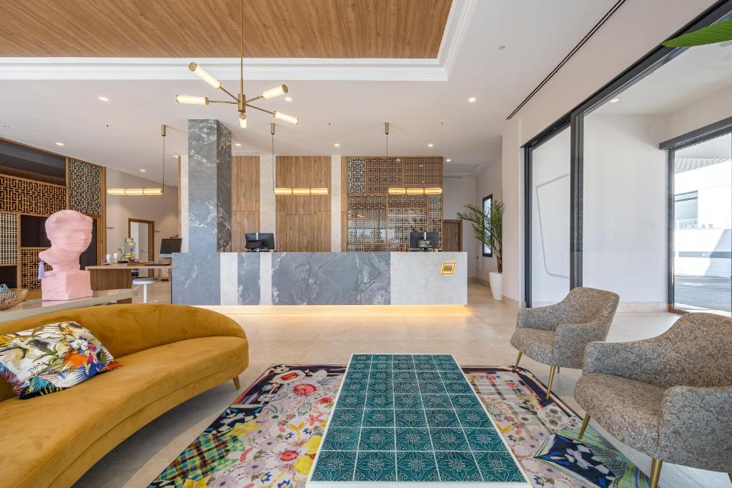 a living room with a couch and a table at ASA Hotel La Marina in Ondara