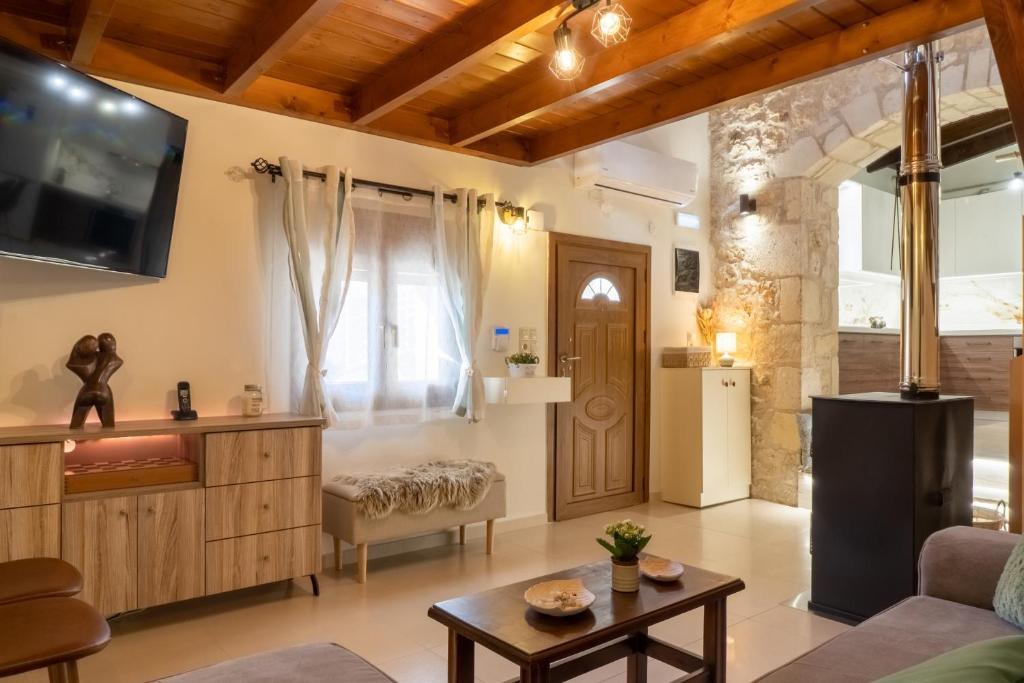 a living room with a couch and a table at Mareu Stonehouse in Panóramo