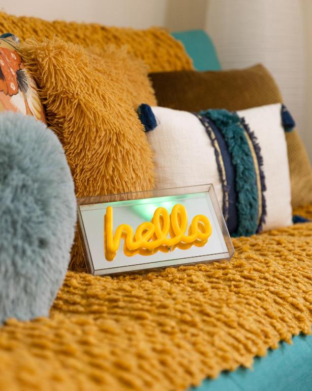 un panneau pour aiki assis au-dessus d'un lit dans l'établissement Sunny Suite by Leslodgespa - Studio moderne et coloré, proche de Bâle et de l'aéroport, à Blotzheim