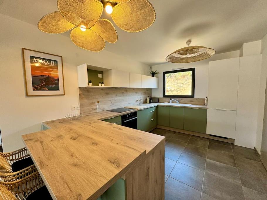a kitchen with a wooden table in a room at Magnifique appart T3 vue mer in Propriano