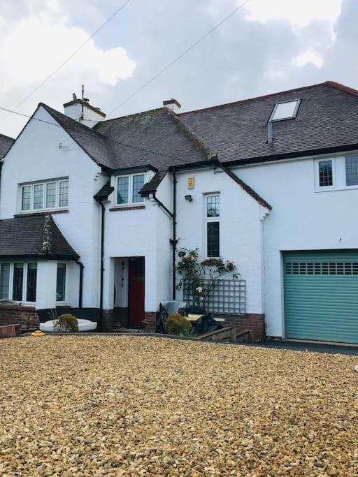 a white house with a driveway in front of it at Otter's Reach in Budleigh Salterton