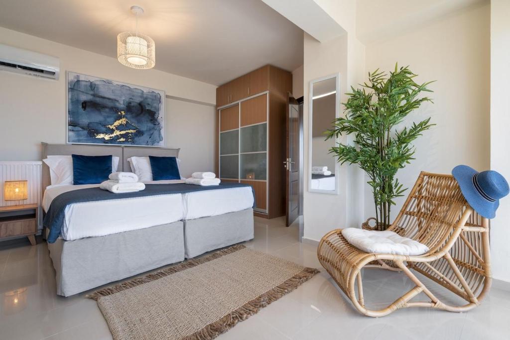 a bedroom with a large bed and a chair at Villa Marathi with stunning ocean view in Chania Town