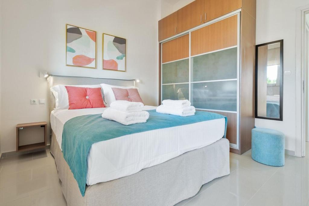 a bedroom with a large bed with towels on it at Villa Marathi with stunning ocean view in Chania Town
