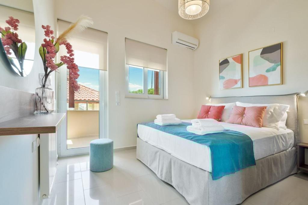 a bedroom with a bed with a blue stool at Villa Marathi with stunning ocean view in Chania Town