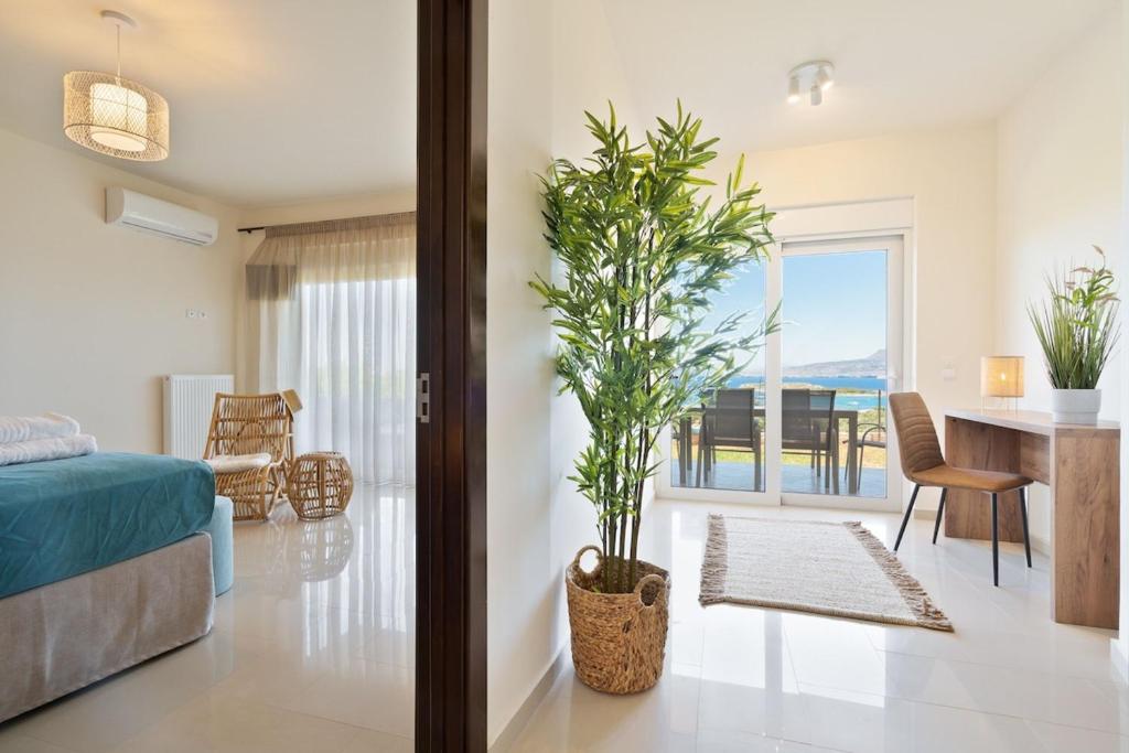a bedroom with a bed and a table with a plant at Villa Marathi with stunning ocean view in Chania Town