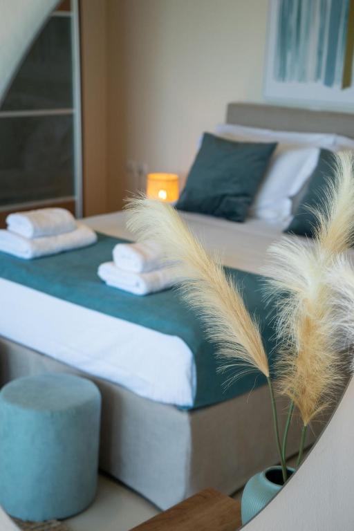 two beds in a room with a potted plant at Villa Marathi with stunning ocean view in Chania Town