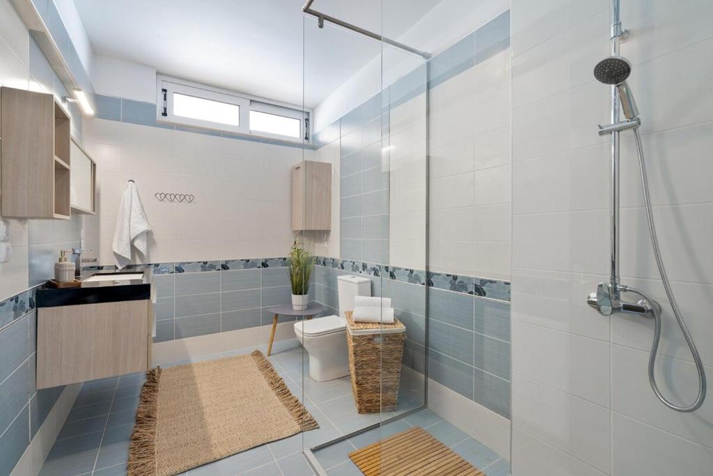 a bathroom with a shower and a toilet and a sink at Villa Marathi with stunning ocean view in Chania Town