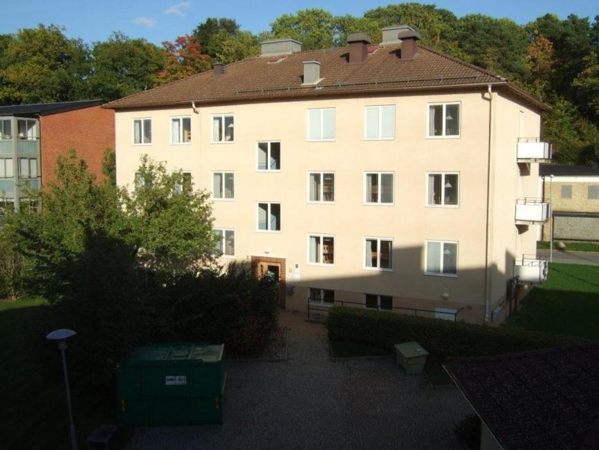 a large white building with a brown roof at Karlshamn vandrarhem och hotell AB in Karlshamn