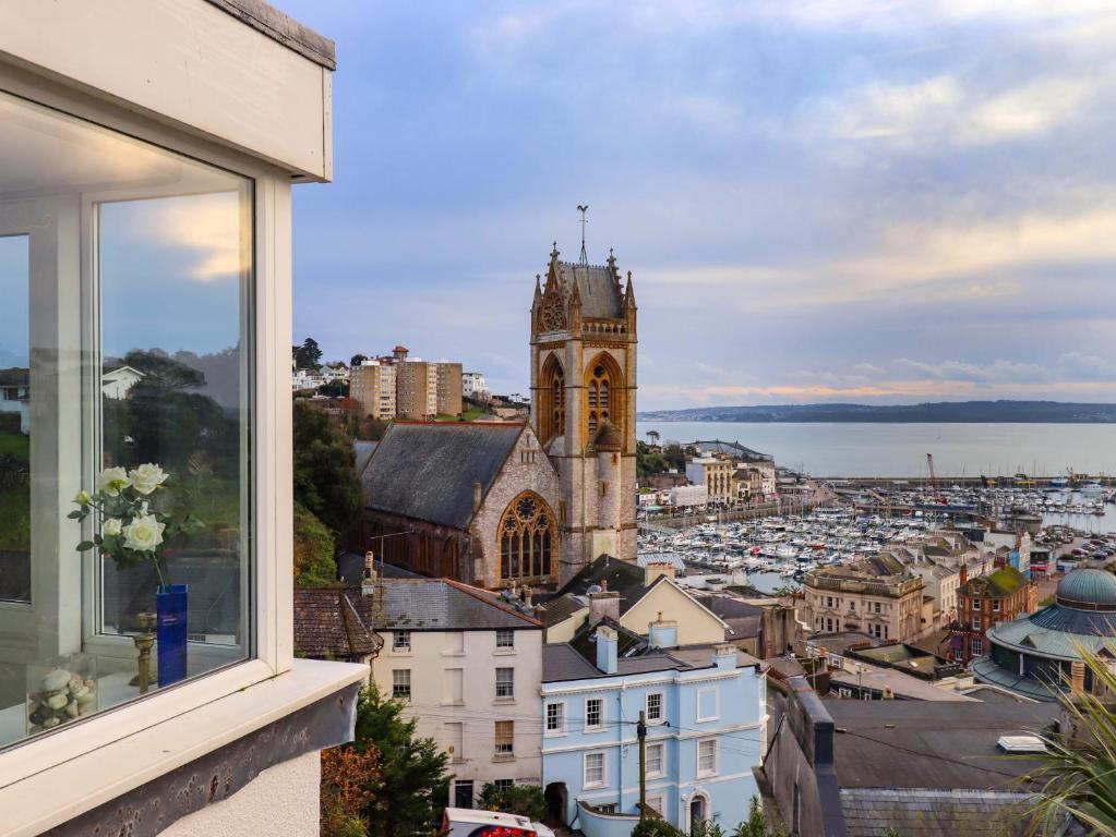 a view from a window of a city with a church at The Grottoes in Torquay