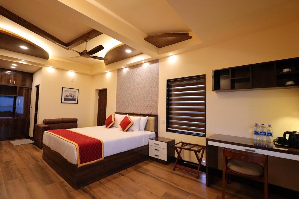 a hotel room with a bed and a desk at Plachoos Gardens - A luxury serviced villa in Kuttikkanam, Peermede in Pīrmed