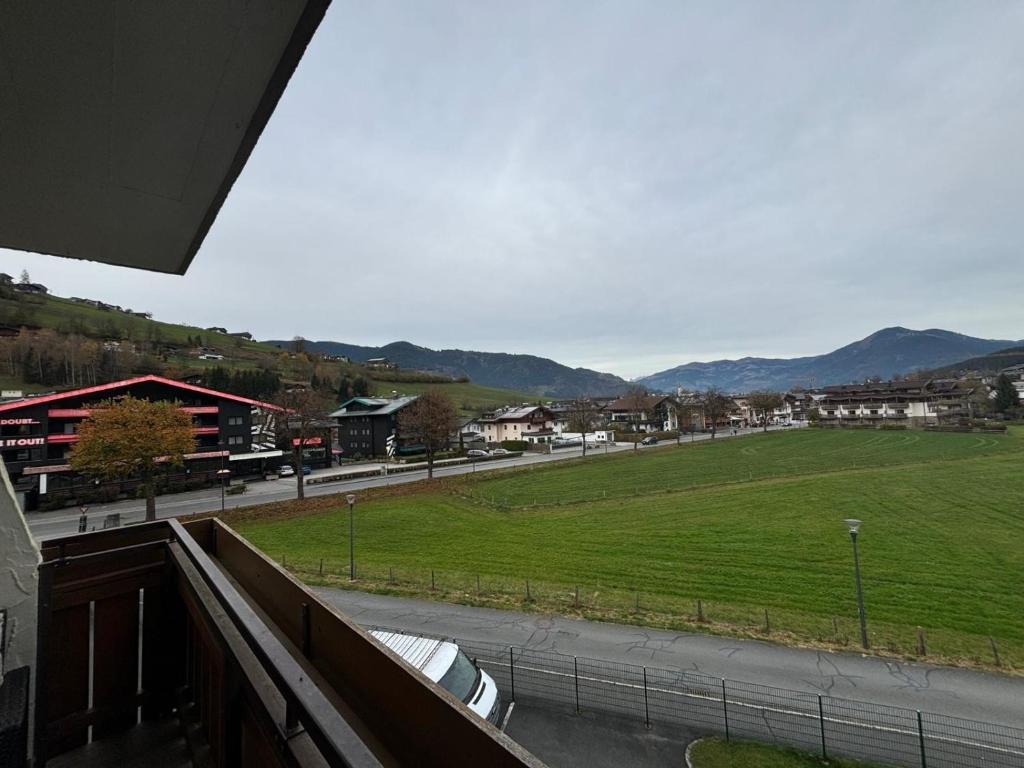 a view of a street with a field and mountains at ApartmentAvenue in Kaprun