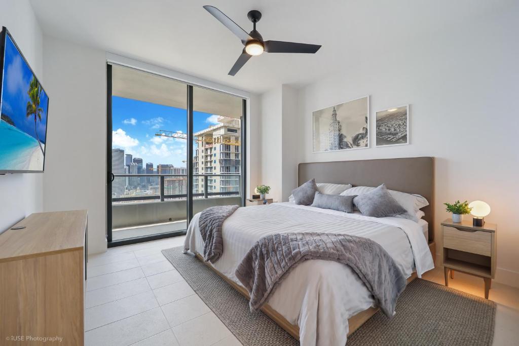a bedroom with a bed and a large window at New unit 28th Floor with Unbeatable Bayside Views in Miami