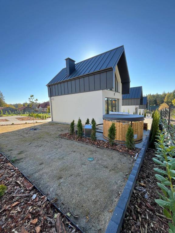 a house with a black roof at Osada Chańcza in Chańcza