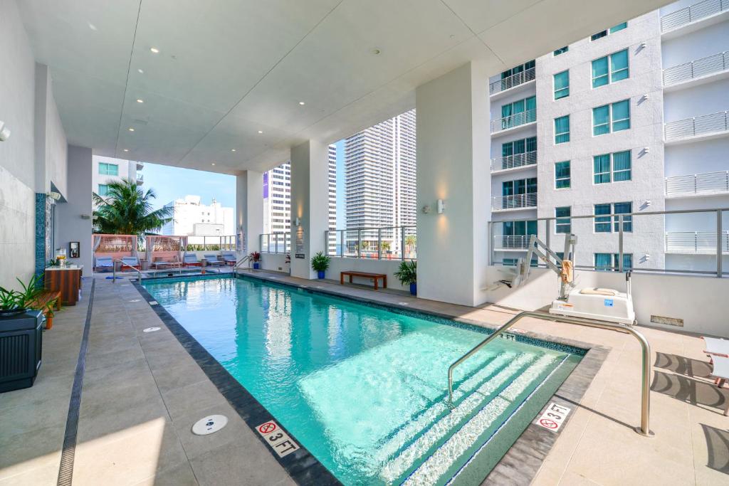 an indoor swimming pool in a building with a building at Luxury One-Bedroom w Top Amenities! in Miami
