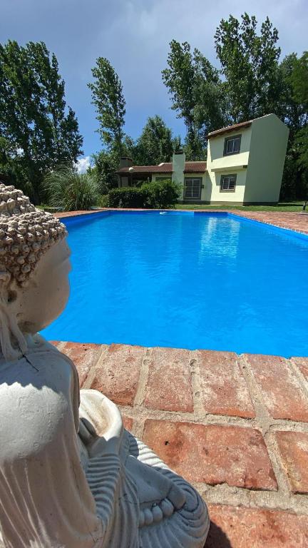 a statue sitting in front of a swimming pool at San Roque in San Roque
