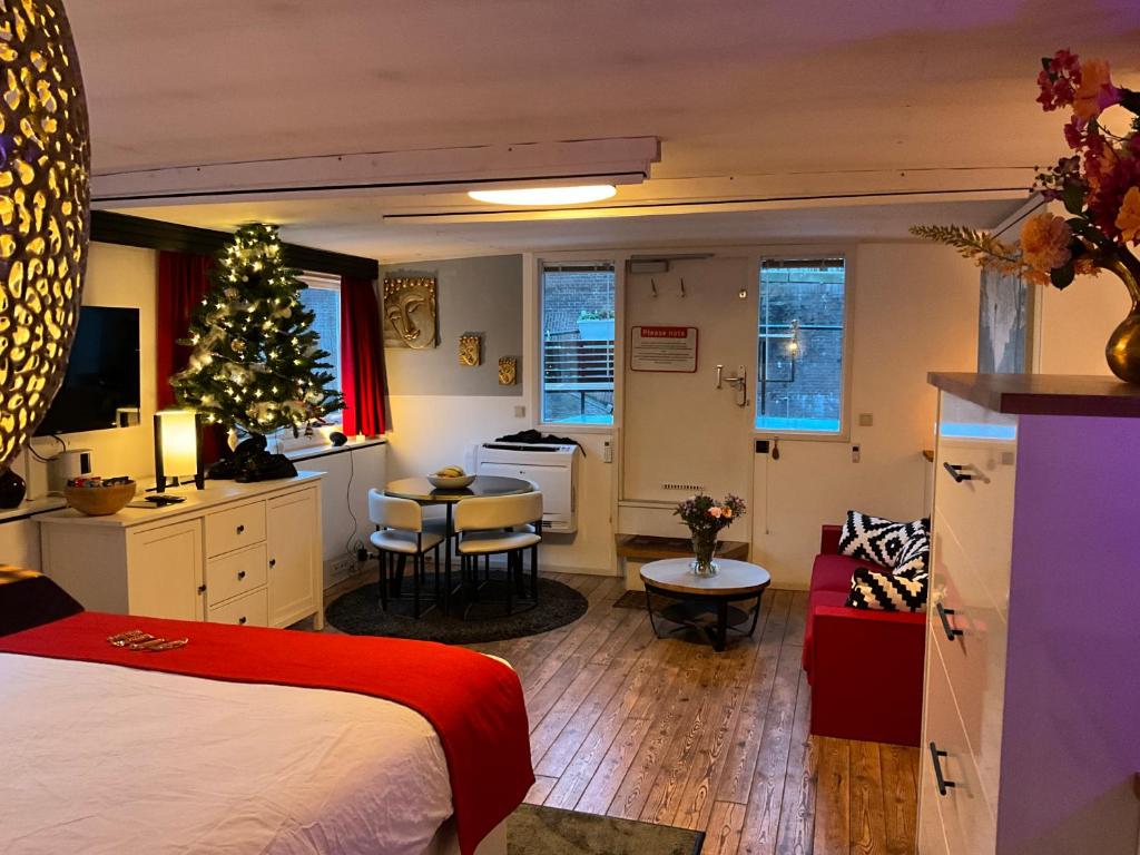 a bedroom with a christmas tree and a living room at Boat no Breakfast in Amsterdam