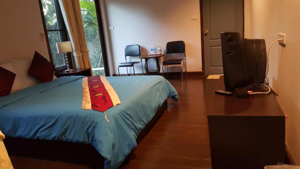 Postel nebo postele na pokoji v ubytování Pai Klang Vieng