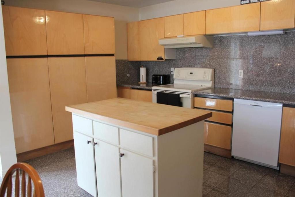 a kitchen with white cabinets and a white stove top oven at Vineyard & Craft House - Rare 6 bedroom Gem in Picton in Picton