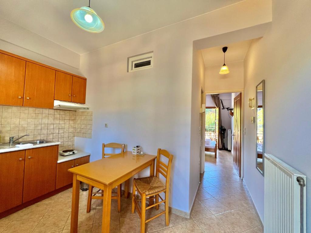 a kitchen and dining room with a table and chairs at Marinos Studios and Apartments in Gialiskari