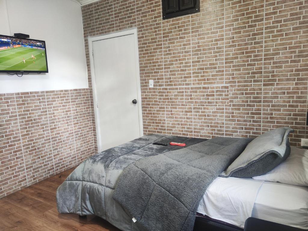 Postel nebo postele na pokoji v ubytování Hotel Muros Quito