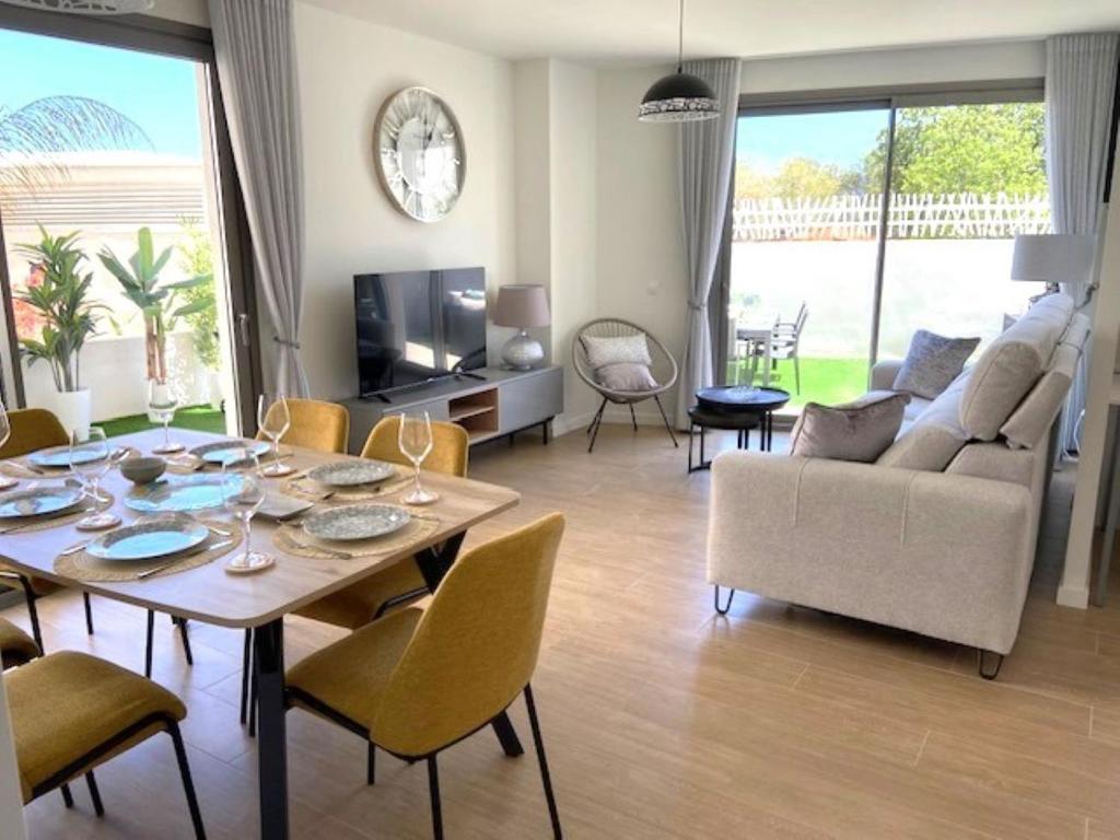 a living room with a table and chairs and a couch at Denia Apartment Rental - Vivir La Vida in Denia