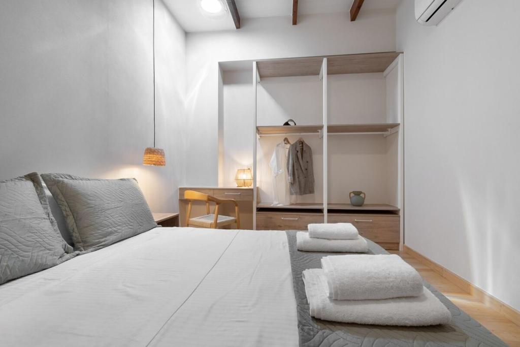 a bedroom with a bed with towels on it at Leo Apartment 2 bdr apt overlooking the harbor in Chania