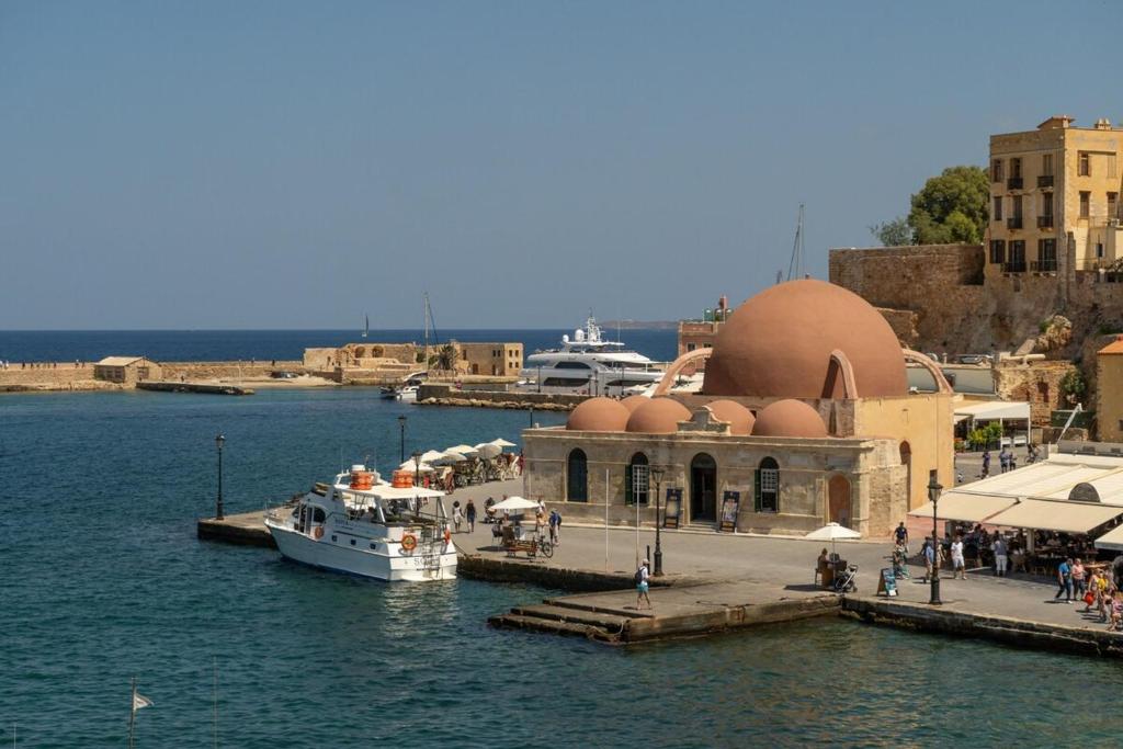 a boat is docked at a dock in the water at Leo Apartment 2 bdr apt overlooking the harbor in Chania