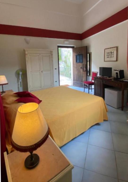 a bedroom with a bed and a table with a lamp at Casa Santicelli - Room in Maratea