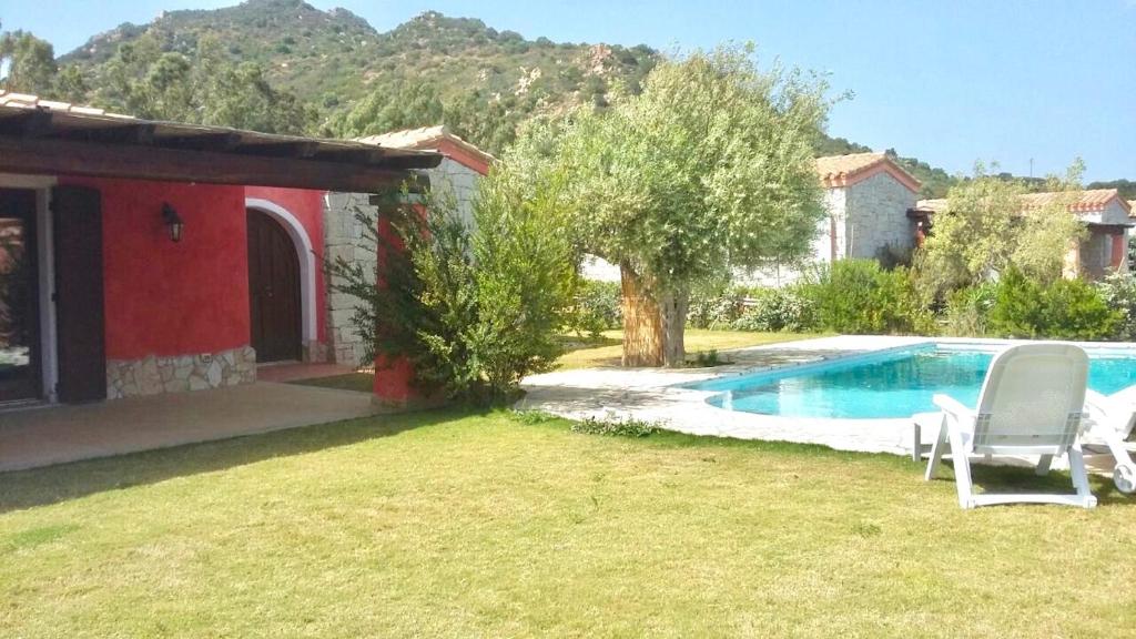 a house with a yard with a swimming pool at Villas with private pool in Costa Rei just 500 meters from the sea in Costa Rei